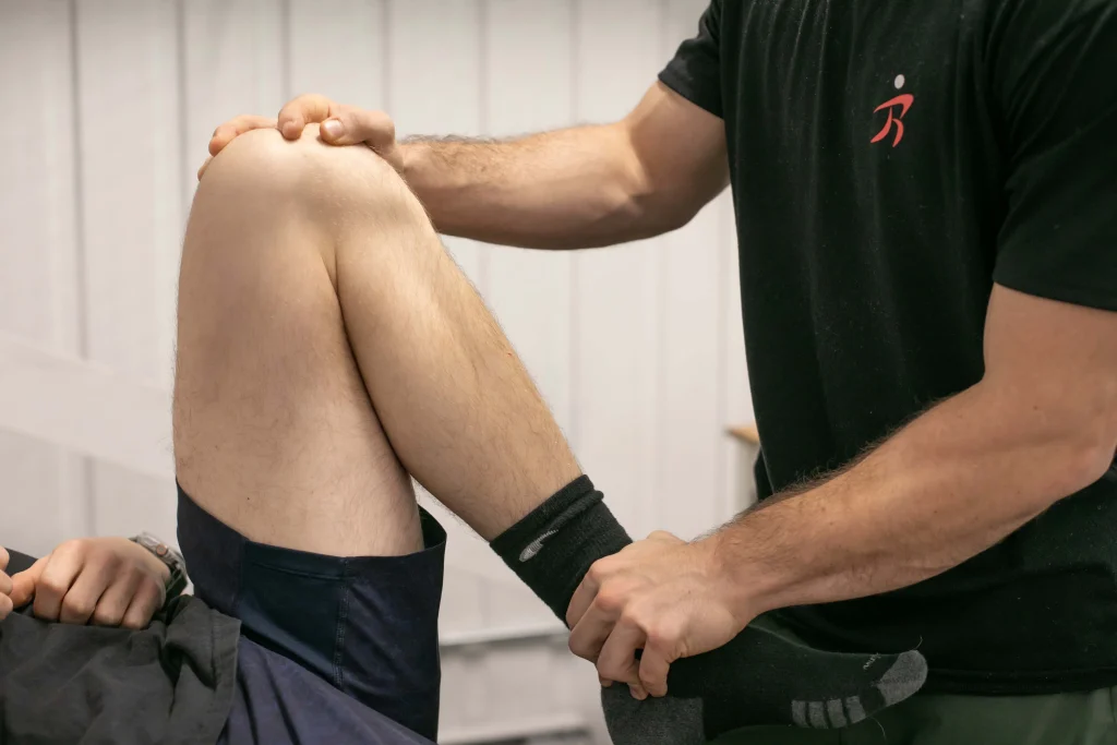 Physical therapist assesses a patient’s knee mobility and lower-leg movement during a rehabilitation session.